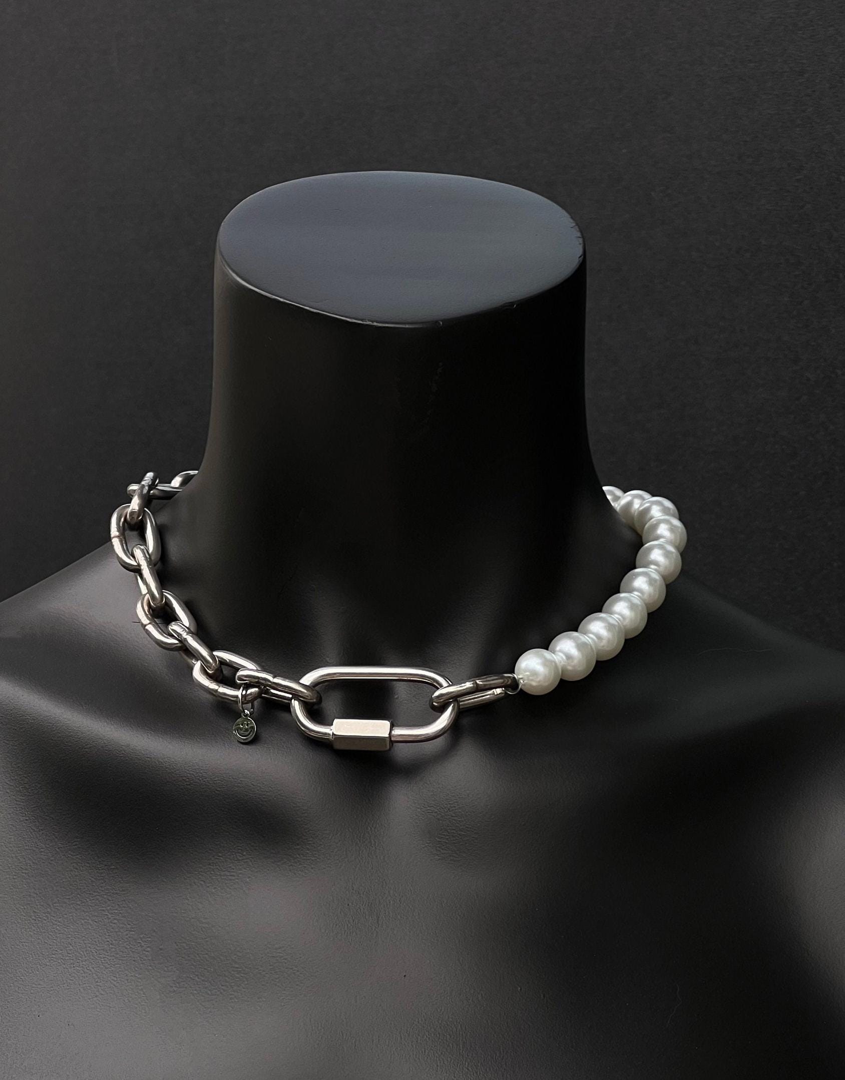 A handmade silver industrial chain necklace with large, chunky, rectangular links. The necklace is made of stainless steel. The necklace is made half-half from thick 4mm chain and 12mm glass white pearl beads. The necklace includes a quick link carabiner and a smiley pendant.