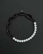 A handmade black industrial chain necklace with large, chunky, rectangular links. The necklace is made of metal steel. The necklace is made half-half from thick 4mm chain and 12mm glass white pearl beads. The necklace includes a black quick link carabiner and a smiley pendant.