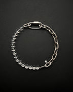 A handmade silver industrial chain necklace with large, rectangular links.
The necklace is made of stainless steel. The necklace is made half-half from thick 4mm chain and 12mm clear glass beads.The necklace includes a quick link carabiner and a smiley pendant.