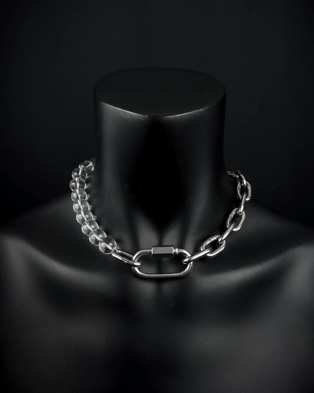 A handmade silver industrial chain necklace with large, chunky, rectangular links. The necklace is made of stainless steel. The necklace is made half-half from thick 4mm chain and 12mm glass transparent beads. The necklace includes a quick link carabiner and a smiley pendant.
