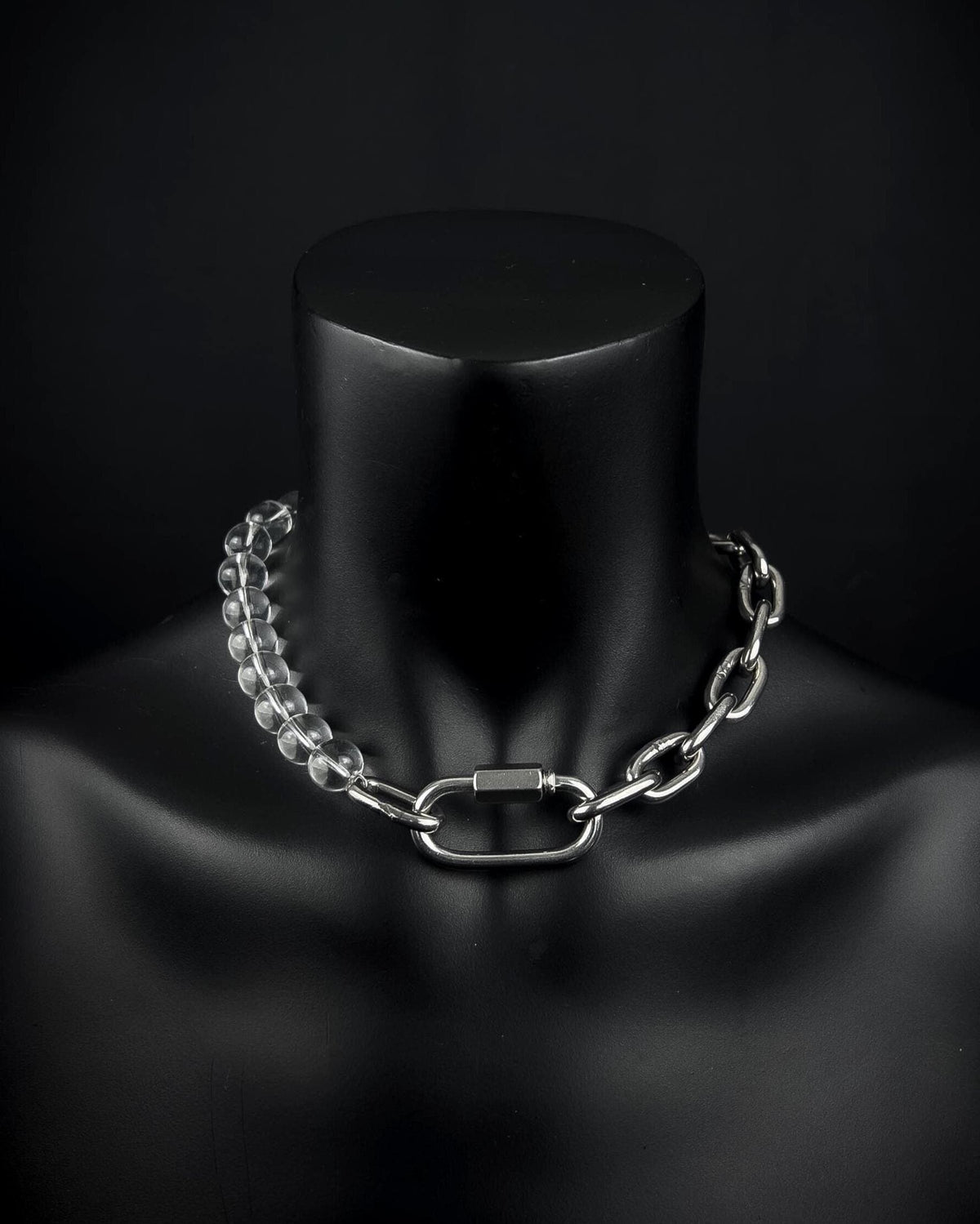 A handmade silver industrial chain necklace with large, chunky, rectangular links. The necklace is made of stainless steel. The necklace is made half-half from thick 4mm chain and 12mm glass transparent beads. The necklace includes a quick link carabiner and a smiley pendant.