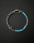 A handmade silver industrial chain necklace with large, rectangular links.
The necklace is made of stainless steel. The necklace is made half-half from thick 4mm chain and 12mm iridescent clear beads.The necklace includes a quick link carabiner and a smiley pendant.