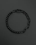 A handmade black industrial chain necklace with large, rectangular links.
The necklace is made of stainless steel. The necklace is made half-half from thick 4mm chain and 12mm glass black beads.The necklace includes a quick link carabiner and a smiley pendant.