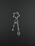 A silver-toned stainless steel keyring featuring a star-shaped ring, a small stainless steel metal spoon charm, a tiny circular smiley face charm, and a clear, faceted, diamond-shaped glass crystal pendant hanging from a short metal chain link.