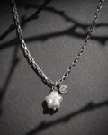 A silver-toned stainless steel chain necklace featuring a star-shaped real baroque white pearl pendant and a small circular charm with an engraved smiley face. The necklace has a box-style link chain design, and the pendant is attached with a simple silver jump ring.