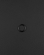 A single, stainless steel circular hoop earring in black finish. The earring features a thin, continuous metal band with a small hinged closure mechanism visible on one side, creating a simple and uniform ring shape for ear piercing.