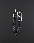 A black paracord keyring featuring a silver-toned stainless steel metal carabiner with an integrated bottle opener. The cord is woven with reflective white threads and finished with two silver metal aglets at the ends and a small circular charm. cyber sigilism style