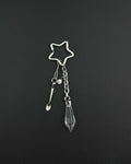 A silver stainless steel keyring featuring a star-shaped ring, a small stainless steel metal spoon charm, a tiny circular smiley face charm, and a clear, faceted, diamond-shaped glass crystal pendant hanging from a short metal chain link.