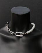A handmade silver industrial chain necklace with large, chunky, rectangular links. The necklace is made of stainless steel. The necklace is made half-half from thick 4mm chain and 12mm glass white pearl beads. The necklace includes a quick link carabiner and a smiley pendant.