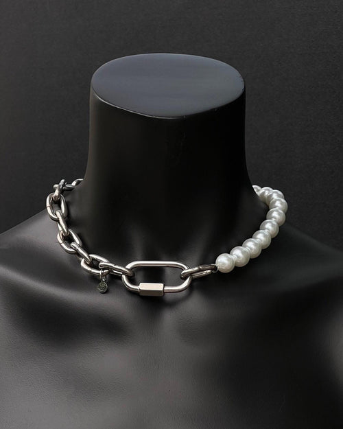A handmade silver industrial chain necklace with large, chunky, rectangular links. The necklace is made of stainless steel. The necklace is made half-half from thick 4mm chain and 12mm glass white pearl beads. The necklace includes a quick link carabiner and a smiley pendant.