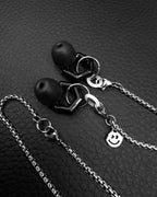 Silver stainless steel cord for ear plugs. Chain for ear protection, earplugs keeper chan. Chain with two dangling chains with concert earplugs attached. Earplugs earrings. Smiling face pendant.