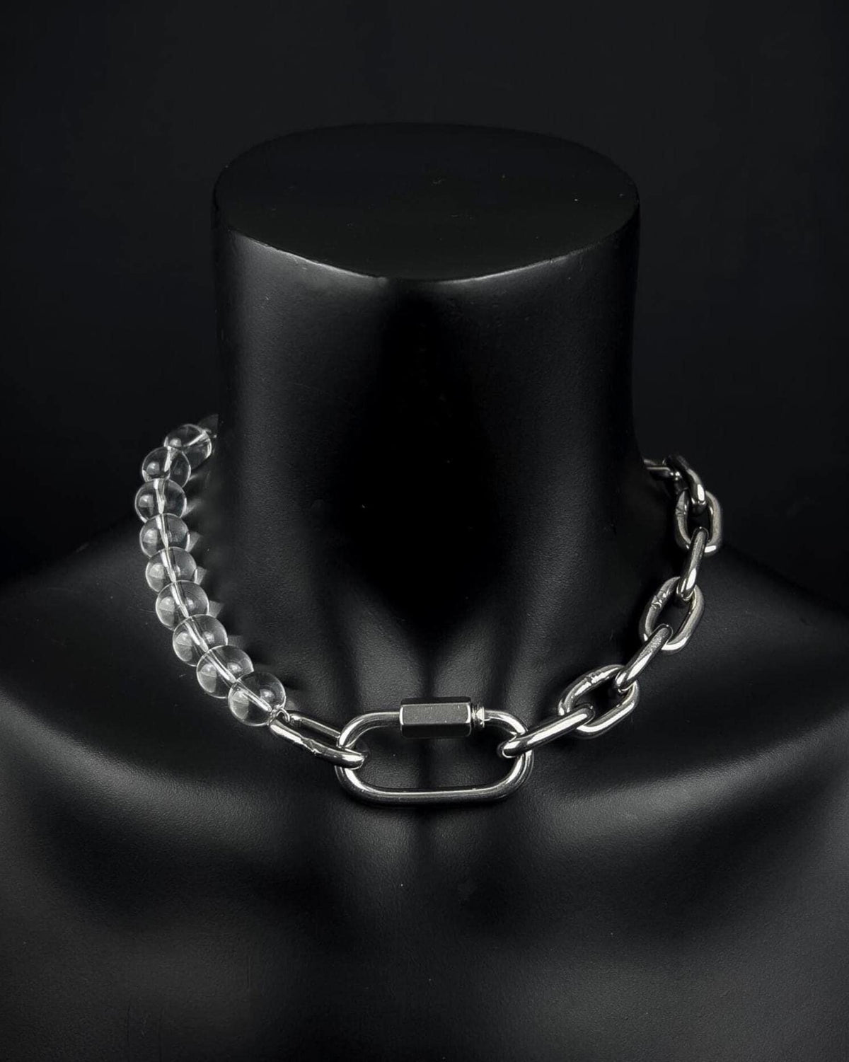 A handmade silver industrial chain necklace with large, chunky, rectangular links. The necklace is made of stainless steel. The necklace is made half-half from thick 4mm chain and 12mm glass transparent beads. The necklace includes a quick link carabiner and a smiley pendant.