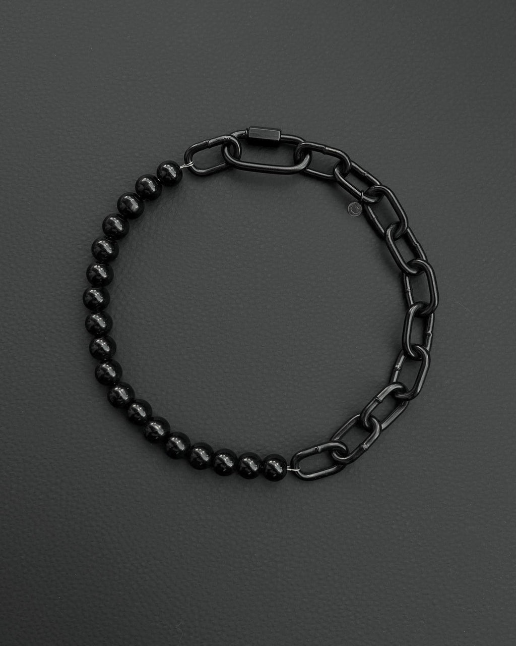 A handmade black industrial chain necklace with large, rectangular links.
The necklace is made of stainless steel. The necklace is made half-half from thick 4mm chain and 12mm glass black beads.The necklace includes a quick link carabiner and a smiley pendant.