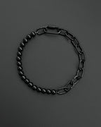 A handmade black industrial chain necklace with large, rectangular links.
The necklace is made of stainless steel. The necklace is made half-half from thick 4mm chain and 12mm glass black beads.The necklace includes a quick link carabiner and a smiley pendant.
